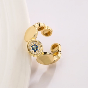 18K gold plated evil eye open ring with blue and white zircons on porcelain background