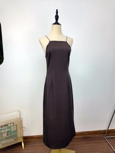 Detail view of deep brown backless maxi dress with spider web hollow design and side slit