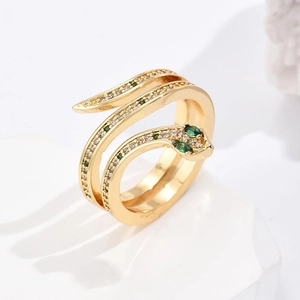 18K gold plated snake ring with green zircon eyes and sparkling stones on white stone