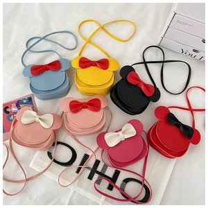 Flat lay of colorful mini bow purses for girls in seven vibrant colors on white background