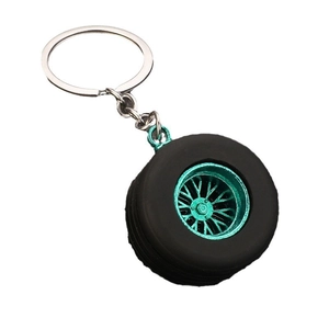 Miniature rubber car tire keychain with cyan alloy rim and silver metal chain link