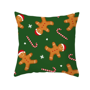 Detailed pattern of gingerbread man and candy canes on green Christmas pillow cover