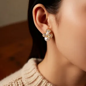 Elegant floral pearl earrings with cubic zirconia inlay shown on model ear profile