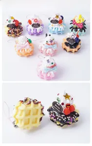 Macro view of realistic PVC waffle dessert keychains with cream and fruit decor