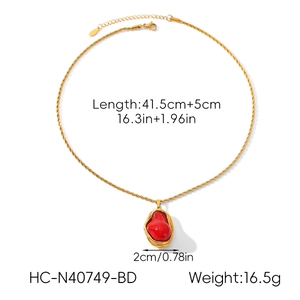 Detailed view of baroque pearl necklace with red resin pendant and 16.3 inch gold chain