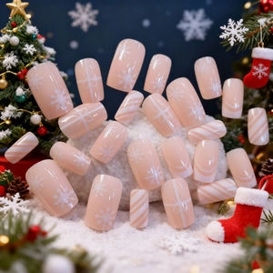 Christmas press-on nails set with festive snowflake and candy stripe patterns on fake snow