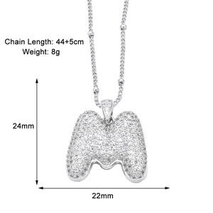 Macro detail of silver M letter pendant with zircon inlay and exact dimensions 24x22mm
