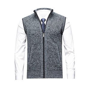 Men's grey knit vest with full zipper and stand collar layered over a white shirt and tie