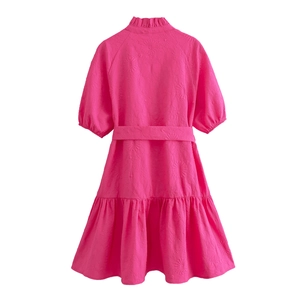 Back view of pink short-sleeve mini dress with textured fabric and ruffle hem