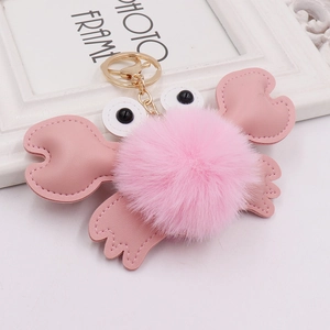 Cute pink plush crab keychain with fuzzy fur ball and golden ring for bags