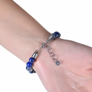 Detail of blue lapis lazuli beaded bracelet with stainless steel tag on wrist