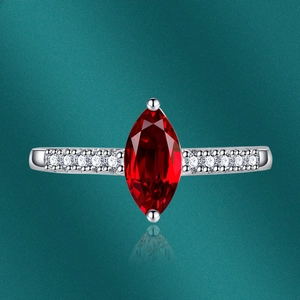 Macro view of marquise cut red ruby ring with side pavé small diamonds in silver