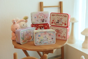 Rectangle metal storage box with cute rabbit illustration on a wooden table