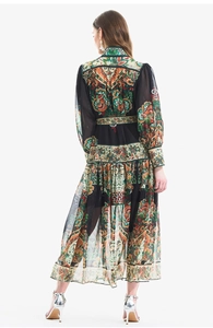 Rear view of long sleeve paisley print dress featuring lantern sleeves and ruffled hem