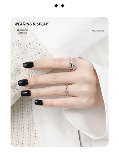 Detail shot of a layered silver lava style ring worn with chic professional attire
