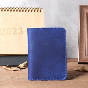 Macro shot of blue crazy horse leather card holder with refined stitching and matte texture