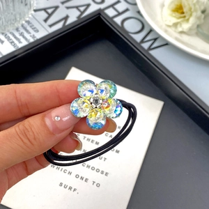Detailed close-up of a high-elastic hair tie featuring a sparkling K9 crystal flower charm