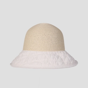 Detail of a straw sun hat featuring a stitched brim and woven breathable crown