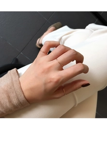 Three minimalist rose gold stacking rings shown on model for a graceful, layered look