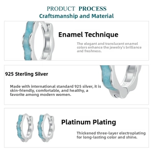 Close-up of sky blue wavy enamel 925 sterling silver earrings with platinum plating details