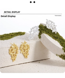 Detailed view of lava-textured irregular stud earrings in gold and silver finishes