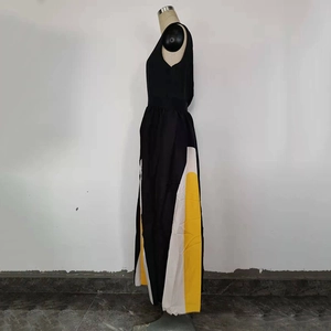 Detail of color-block sleeveless maxi dress showing side patchwork in black white and yellow