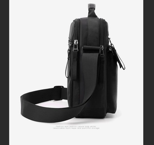Detail view of water-resistant nylon shoulder bag with adjustable strap and side zippers