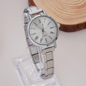 Detailed view of women's quartz watch with silver link band and Roman numeral dial