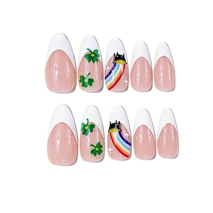 Detailed view of almond fake nails with green clovers, rainbows, and French tips