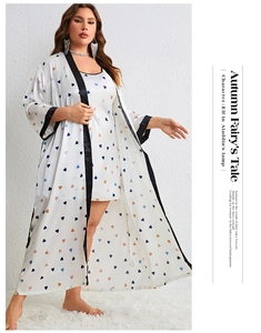 Detail of two-piece pajama set featuring colorful heart prints and black contrast piping