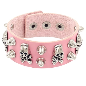 Close-up of pink PU leather bracelet with silver skull charms and metallic cone studs