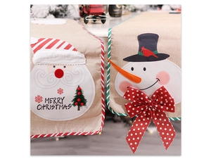 Close-up of burlap Christmas table runner with 3D snowman and Santa Claus embroidery