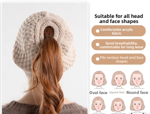 Detail of beige acrylic ponytail beanie showing the top opening and thick knit texture