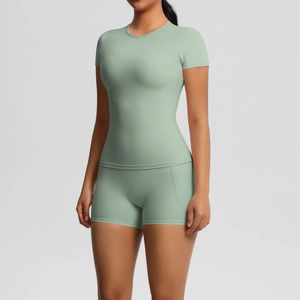 Detailed stitching and ergonomic seam design on green yoga top and shorts set