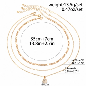 Detailed view of triple-layered gold necklaces with rhinestone pendant and length specs
