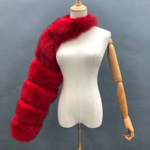 Detail of bright red faux fox fur shawl showing premium segmented sewing and plush texture