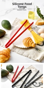 Close-up of heat-resistant silicone food tongs in red, black, and grey for kitchen use