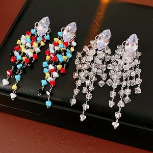 Close-up of geometric zircon tassel earrings in colorful and clear crystal styles