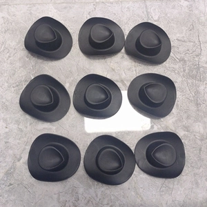 Macro view of nine black miniature cowgirl hats in a grid for DIY crafts and doll decor