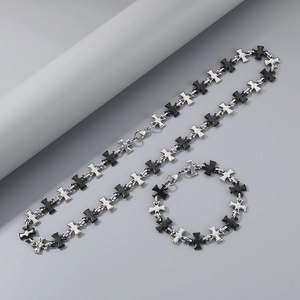 Detailed view of silver and black stainless steel cross link chain necklace and bracelet