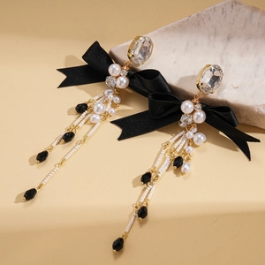 Elegant bow and pearl tassel earrings with crystal studs and long golden chain fringe