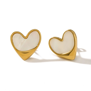 Minimalist gold heart earrings with white mother of pearl inlay on white background