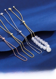 Detail view of S925 sterling silver box chain bracelets with adjustable beads and heart pendants