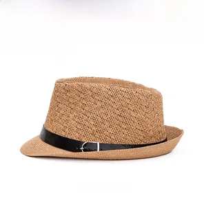 Detail of hand-woven straw fedora hat featuring a black band and silver buckle