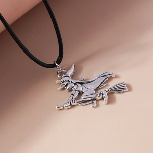 Detail of silver witch on a broomstick pendant with black cord necklace chain