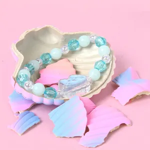 Water-hatch shell toy with hidden blue bead bracelet featuring a cute cartoon cat charm