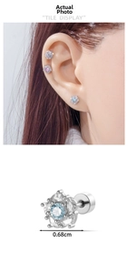 Detail view of flower stud earring with light blue gem and clear zircon crystals