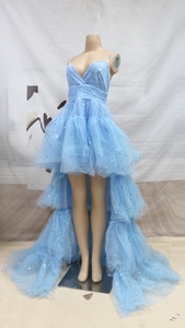 Detail of light blue tulle wedding dress with silver star sequins and V-neck straps