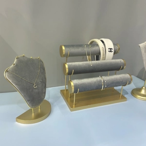 Golden metal and grey velvet jewelry display stand set for necklaces and bracelets