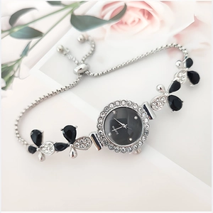 Detail of silver leaf bracelet watch with black dial and adjustable bolo clasp